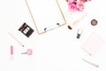 Workspace with pastel roses bouquet, cosmetics, diary and clipboard on white background. Top view. Flat lay. Beauty blog with copy Royalty Free Stock Photo