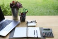 Workspace relaxing chill out work for office and laptop computer, Calculator and other stationary on wood table with green garden