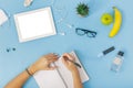 Workspace tablet, girls hands, notebook, spectacles Female hands