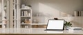 Workspace with tablet mockup and copy space over blurred background of minimal working room