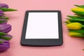 Tulips and tablet with white mockup screen on pink background. Greeting card for Easter or Women`s Day Royalty Free Stock Photo