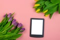 Tulips and tablet with white mockup screen on pink background. Greeting card for Easter or Women`s Day Royalty Free Stock Photo