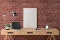 Workspace with vertical poster mock up on the desk. Desk with drawers in interior of the studio or at home with red brick wall. Royalty Free Stock Photo