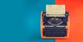 Workspace with vintage orange typewriter Royalty Free Stock Photo