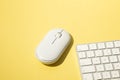 workspace with a white wireless mouse and computer keyboard on a yellow background Royalty Free Stock Photo