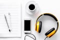 Worktable of composer today. Headphones, phone, music notes on white background top view Royalty Free Stock Photo