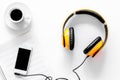 Worktable of composer today. Headphones, phone, music notes on white background top view Royalty Free Stock Photo