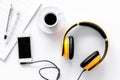 Worktable of composer today. Headphones, phone, music notes on white background top view Royalty Free Stock Photo