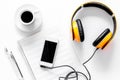 Worktable of composer today. Headphones, phone, music notes on white background top view Royalty Free Stock Photo