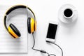 Worktable of composer today. Headphones, phone, music notes on white background top view Royalty Free Stock Photo