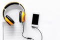 Worktable of composer today. Headphones, phone, music notes on white background top view copyspace Royalty Free Stock Photo