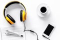 Worktable of composer today. Headphones, phone, music notes on white background top view Royalty Free Stock Photo