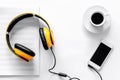 Worktable of composer today. Headphones, phone, music notes on white background top view Royalty Free Stock Photo