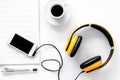 Worktable of composer today. Headphones, phone, music notes on white background top view Royalty Free Stock Photo