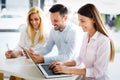 Workteam in office working together on laptop Royalty Free Stock Photo