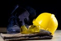 Workwear for a construction worker. Helmet, gloves, shoes and sunglasses on a wooden table. Royalty Free Stock Photo