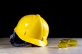 Workwear, helmet, gloves and glasses on a wooden working table. Royalty Free Stock Photo