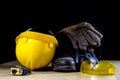 Workwear, helmet, gloves and glasses on a wooden working table. Royalty Free Stock Photo