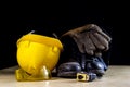 Workwear, helmet, gloves and glasses on a wooden working table. Royalty Free Stock Photo