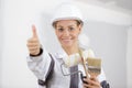 workwoman gives thumbs up in front Royalty Free Stock Photo