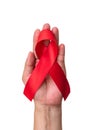 World aids day and national HIV AIDS and ageing awareness month with red ribbon on helping hand Royalty Free Stock Photo