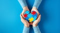 World autism awareness day concept. Adult and child hands holding puzzle heart on light blue background, AI generated Royalty Free Stock Photo