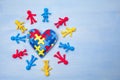 World Autism Awareness day, mental health care concept with puzzle or jigsaw pattern on heart with kids figures Royalty Free Stock Photo