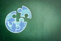 World Autism Awareness Day Month idea concept with big globe jigsaw puzzle piece doodle on green chalkboard Royalty Free Stock Photo
