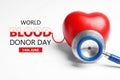 World Blood Donor Day. Stethoscope and heart model on white background, closeup