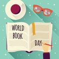 World book day, open book with a hand writing, coffee cup and glasses Royalty Free Stock Photo