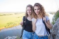 A world without borders. Stunning journey of two girls in the mountains. Two girls at the top of the mountain rejoice in Royalty Free Stock Photo