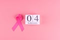 World cancer day with calendar of February 4 and Pink Ribbon supporting people living and illness. Healthcare concept