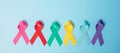 World cancer day February 4. colorful awareness ribbons; blue, red, teal, pink, purple and yellow color on wooden background for