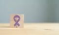 World Cancer Day (February 4) concept. Lavender ribbon (all cancer) icon on wooden Royalty Free Stock Photo