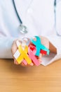 World cancer day, February 4. Doctor hold colorful ribbons, blue, yellow, red, green, white, pink and grey for supporting people Royalty Free Stock Photo