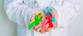 World cancer day, February 4. Doctor hold colorful ribbons, blue, yellow, red, green, white, pink and grey for supporting people Royalty Free Stock Photo