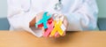 World cancer day, February 4. Doctor hold colorful ribbons, blue, yellow, red, green, white, pink and grey for supporting people Royalty Free Stock Photo