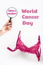 World cancer day. Pink lace bra on a white background and a woman& x27;s hand with a magnifying glass. Vertical orientation Royalty Free Stock Photo