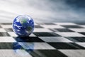 World on a chessboard on blue sky background