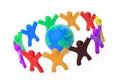 World Communication Concept. Plasticine Clay Colorful People around of Earth Globe Modeling from Plasticine Blue and Green Clay. Royalty Free Stock Photo