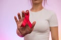 World company of AIDS day. Red ribbon on human hand close up Royalty Free Stock Photo