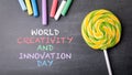 World Creativity and Innovation Day. Colored pieces of chalk on a dark board Royalty Free Stock Photo