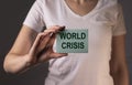 World crisis inscription on paper in female hands