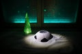 World cup at wintertime concept. Football Soccer ball on snowy decorated table with toy miniatures. New Year Christmas theme. Royalty Free Stock Photo