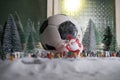 World cup at wintertime concept. Football Soccer ball on snowy decorated table with toy miniatures. New Year Christmas theme. Royalty Free Stock Photo