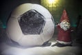 World cup at wintertime concept. Football Soccer ball on snowy decorated table with toy miniatures. New Year Christmas theme. Royalty Free Stock Photo