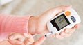 World diabetes day concept. Close up hands holding lancing device with blood to checking blood sugar level by Glucose meter for Royalty Free Stock Photo