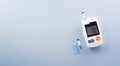 World Diabetes day concept ,14 November. Top view of blood glucose meter sets on pastel blue background
