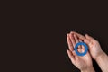 World diabetes day inscription. Blue circle in woman hands on a black background. 14 november