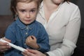 The little girl is crying and doesn`t want to give the injection. Mom persuades her daughter to take an insulin injection.